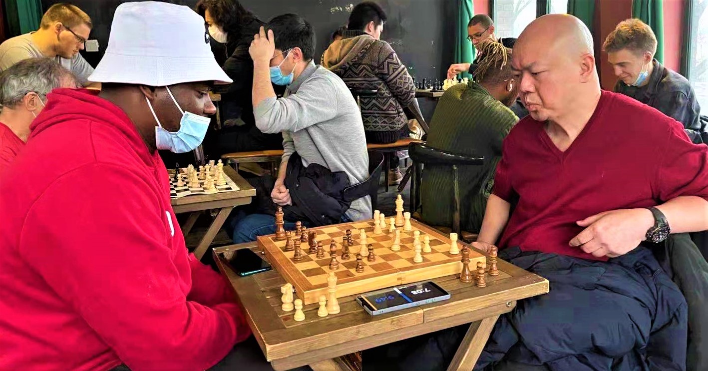 Jing&#039;s Gambit: Chess Players Trade Pieces at the Camera Stylo Club